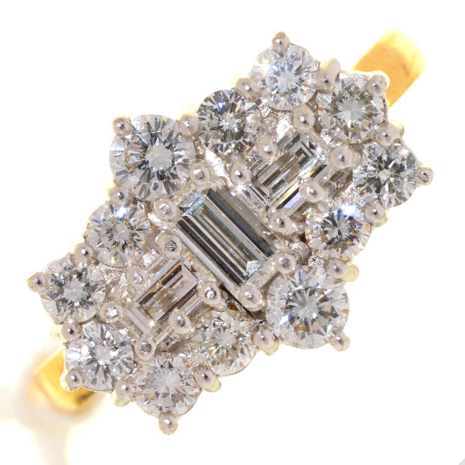 A DIAMOND CLUSTER RING WITH THREE LARGER CENTRAL EMERALD CUT DIAMONDS, IN 18CT GOLD, LONDON 2001,