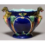 A MAJOLICA JARDINIERE, C1890, WITH GROTESQUE HANDLES AND STRAPWORK RELIEFS, THE INTERIOR
