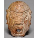 A SOUTH EAST ASIAN CARVED STONE MASK, 19.5CM H Minor abrasions and slight chips