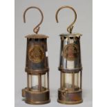 TWO BRASS AND FERROUS METAL MINER'S SAFETY LAMPS BY THE PROTECTOR LAMP AND LIGHTING CO LTD, 20TH