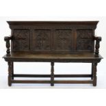 A 19TH C CARVED OAK SETTLE INCORPORATING EARLIER ELEMENTS, 152CM W, 96CM H Scuffs, scratches and