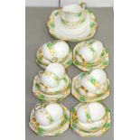A PARAGON BONE CHINA TEA SERVICE, C1940, WITH GREEN, YELLOW AND BLUE STYLISED FLORAL BORDER, PRINTED