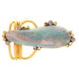 AN OPAL AND DIAMOND RING, THE IRREGULAR OPAL SECTION WITHIN DIAMOND ACCENTS, IN GOLD, WIREWORK HOOP,