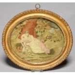 A REGENCY SILK PICTURE OF A YOUNG WOMAN EMBLEMATIC OF TENDERNESS, C1820, WITH PAINTED BACKGROUND,