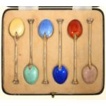 A SET OF SIX EDWARD VIII SILVER GILT AND HARLEQUIN GUILLOCHE ENAMEL COFFEE SPOONS, SEAL TERMINAL, BY