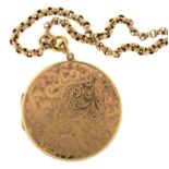A 9CT GOLD LOCKET, ENGRAVED WITH LEAFY SCROLLS, 42MM DIAM, BIRMINGHAM 1987 AND A GOLD CHAIN, 31G (2)