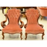A VICTORIAN WALNUT ARMCHAIR AND A MATCHING NURSING CHAIR, C1870, THE BACK CRESTED BY CRISPLY