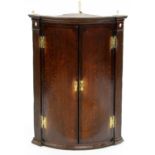 A GEORGE III OAK BOW FRONTED CORNER CUPBOARD, 28CM H; 69 X 46CM Numerous scuffs and scratches,