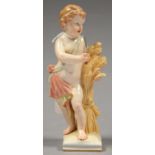 A BERLIN FIGURE OF A CHILD, 20TH C, EMBLEMATIC OF AUTUMN FROM THE FOUR SEASONS, NAKED BUT FOR A