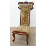 A VICTORIAN CARVED ROSEWOOD AND BERLIN WOOLWORK PRIE DIEU, C1850, ON BRASS CASTORS, 118CM H, SEAT
