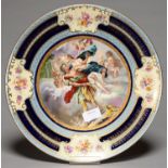 A VIENNA STYLE PLAQUE, EARLY 20TH C, PRINTED AND PAINTED WITH A MYTHOLOGICAL SCENE IN RAISED GILT