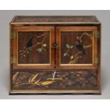 A JAPANESE MARQUETRY AND LACQUER TABLE CABINET, MEIJI PERIOD, THE DOORS DECORATED IN HORN AND