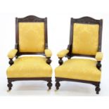 A PAIR OF VICTORIAN CARVED TURNED MAHOGANY OPEN ARMCHAIRS, UPHOLSTERED IN GOLD FABRIC, ON BRASS