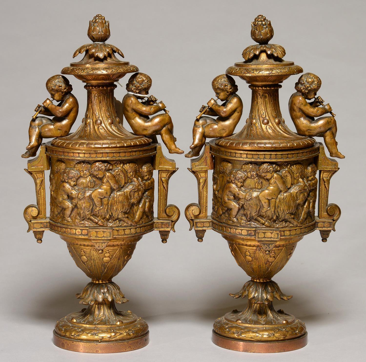 A PAIR OF FRENCH FIN DE SIECLE GILT LAQUERED AND BRONZED METAL URNS AND COVERS, C1900, THE DOMED