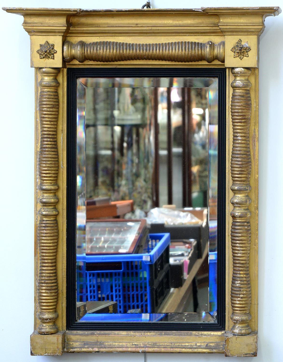 AN EARLY VICTORIAN GILTWOOD AND COMPOSITION PIER GLASS, THE BEVELLED MIRROR IN REEDED EBONISED