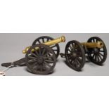 A PAIR OF BRASS MODEL  CANNON, ON IRON CARRIAGE, BARREL 13CM L Good condition