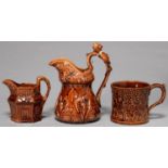 TWO ROCKINGHAM BROWN GLAZED JUGS AND A MUG, MID 19TH C, THE SMALLER HEXAGONAL JUG OF COTTAGE FORM,