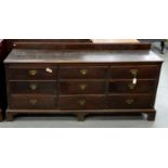 A GEORGE III OAK DRESSER ON BRACKET FEET, WITH NINE MOULDED DRAWERS, 94CM H; 198 X 52CM Handles