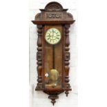 A CARVED WALNUT VIENNA WALL CLOCK WITH ENAMEL DIAL, EARLY 20TH C, 130cm h, 53CM W Chips and losses