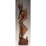 A SOUTH EAST ASIAN CARVED WOOD FIGURE OF A WOMAN, 59CM H Tiny damage to top most point of headdress
