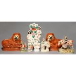 A PAIR OF STAFFORDSHIRE EARTHENWARE MODELS OF GLASS EYED RECUMBENT LIONS, C1900, 23CM H AND SIX 19TH