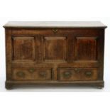 A GEORGE III PANELLED OAK MULE CHEST WITH BOARDED LID, THE INTERIOR WITH A TILL, ON LATER BRASS