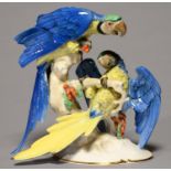A CONTINENTAL PORCELAIN GROUP OF PARROTS, C1970, ON DOMED OVAL GILT BASE, 29CM H Good condition