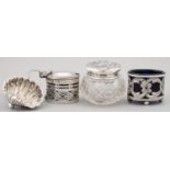 TWO PIERCED OVAL SILVER CONDIMENT POTS, A SHELL SHAPED SALT CELLAR AND CUT GLASS JAR WITH SILVER