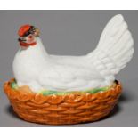 A CONTINENTAL EARTHENWARE HEN AND NEST EGG BOX AND COVER, C1870, THE SITTING BIRD IN WHITE