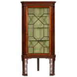 A GEORGE III MAHOGANY CORNER CABINET, LATE 18TH C, WITH DENTIL CORNICE AND STOP FLUTED UPRIGHTS