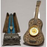 A DECORATIVE SILVERED METAL AND WOOD GUITAR SHAPED STRUT TIMEPIECE, THE BRITISH UNITED CLOCK CO