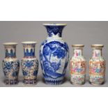 A PAIR OF CANTON FAMILLE ROSE VASES, 19TH C, TYPICALLY ENAMELLED WITH PANELS OF FIGURES,
