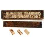 A SET OF VICTORIAN BONE 1" DOMINOES, MID 19TH C, IN A STAINED SOFT WOOD BOX WITH SLIDING LID Light