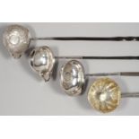 FOUR SILVER PUNCH LADLES, THE BOWL OF EACH INSET WITH A COIN, ONE ADAPTED FROM A PAP BOAT,