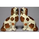 A PAIR OF STAFFORDSHIRE COPPER LUSTRE MODELS OF SPANIELS, C1900, 38CM H Both in the same good