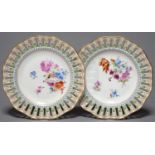 A PAIR OF CONTINENTAL PORCELAIN RIBBON PLATES, C1900, PAINTED WITH A LOOSE BOUQUET AND SCATTERED