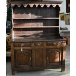 AN OAK DRESSER, 19TH C, THE RACK WITH MOULDED CORNICE, IRON HOOKS AND BOARDED BACK, THE BASE