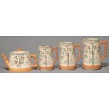A GRADUATED SET OF THREE AESTHETIC BROWNHILLS POTTERY CO EARTHENWARE JUGS AND A MATCHING TEAPOT