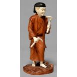 A JAPANESE IVORY AND BOXWOOD OKIMONO OF A FARMER, MEIJI PERIOD, HOLDING A PLANT AND MATTOCK, 19CM H,