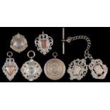 SEVEN  SILVER WATCH FOB SHIELDS, EARLY 20TH C, VARIOUS SIZES, SEVERAL ENGRAVED WITH INSCRIPTIONS,