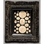 A FRAMED GROUP OF PLASTER CASTS OF CLASSICAL STYLE INTAGLIOS, THE LARGER THREE OF THE PENITENT