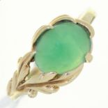 A JADE RING, THE CABOCHON IN LEAFY SETTING,  IN GOLD MARKED 14K, 3.5G, SIZE P Good condition