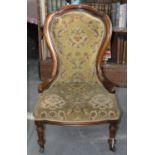 A VICTORIAN WALNUT NURSING CHAIR, C1870 The back slightly loose and a couple of old chips on
