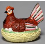 A STAFFORDSHIRE EARTHENWARE HEN AND NEST EGG BOX AND COVER, MID 19TH C, THE SITTING BIRD DECORATED