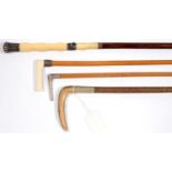 A FINE VICTORIAN IVORY HANDLED LIGHTWOOD LADY'S RIDING CROP AND ANOTHER WITH SILVER HANDLE, BOTH