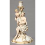 A MEISSEN FIGURAL CANDLESTICK, LATE 19TH C, IN THE FORM OF A SEMI-NAKED SEATED YOUTH AND CHILD