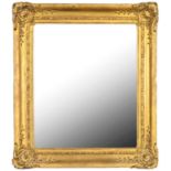 A WALL MIRROR REUSING A VICTORIAN GILTWOOD AND COMPOSITION PICTURE FRAME, LATE 19TH C, 98 X 84CM