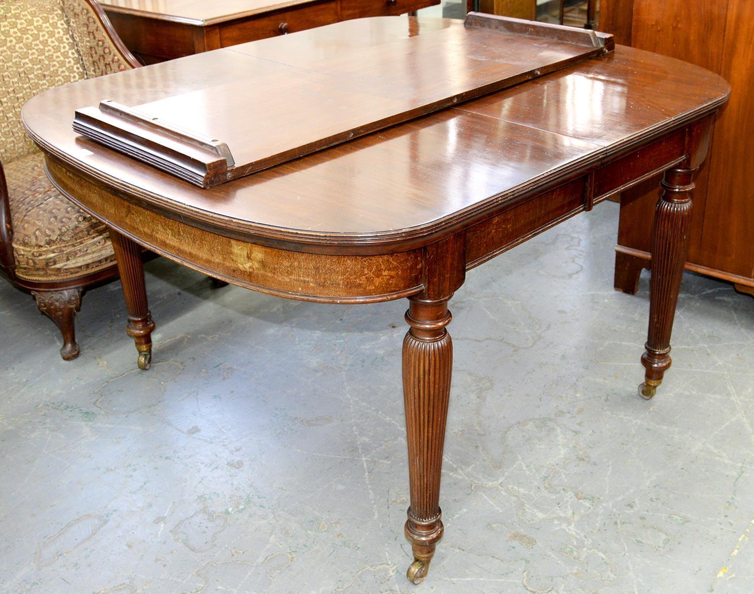 A VICTORIAN MAHOGANY DINING TABLE, C1890, THE TOP WITH D SHAPED ENDS ON FINELY REEDED INVERTED