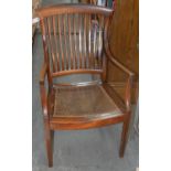 AN EDWARDIAN MAHOGANY STICK BACK ELBOW CHAIR WITH DISHED, CANED SEAT, C1910 Typical wear