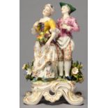 A GERMAN PORCELAIN GROUP OF RUSTIC LOVERS, 20TH C, THE YOUTH PLACING AN ARM AROUND THE WAIST OF